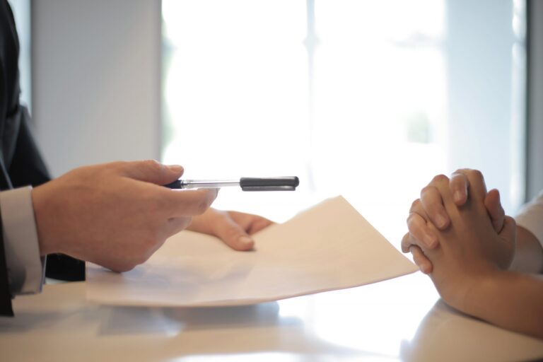 crop-businessman-giving-contract-to-woman-to-sign-3760067-scaled