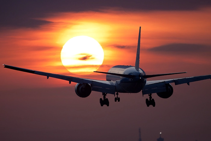 Airplane taking off into the sunset