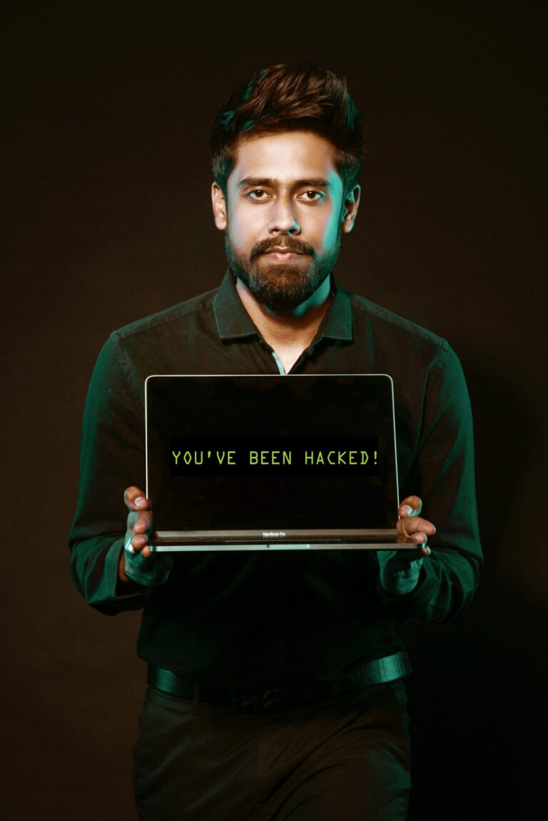 man-holding-hacked-laptop-computer-scaled