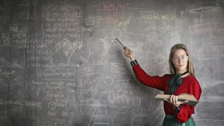 strict-female-teacher-with-book-pointing-at-scribbled-3771074-edited